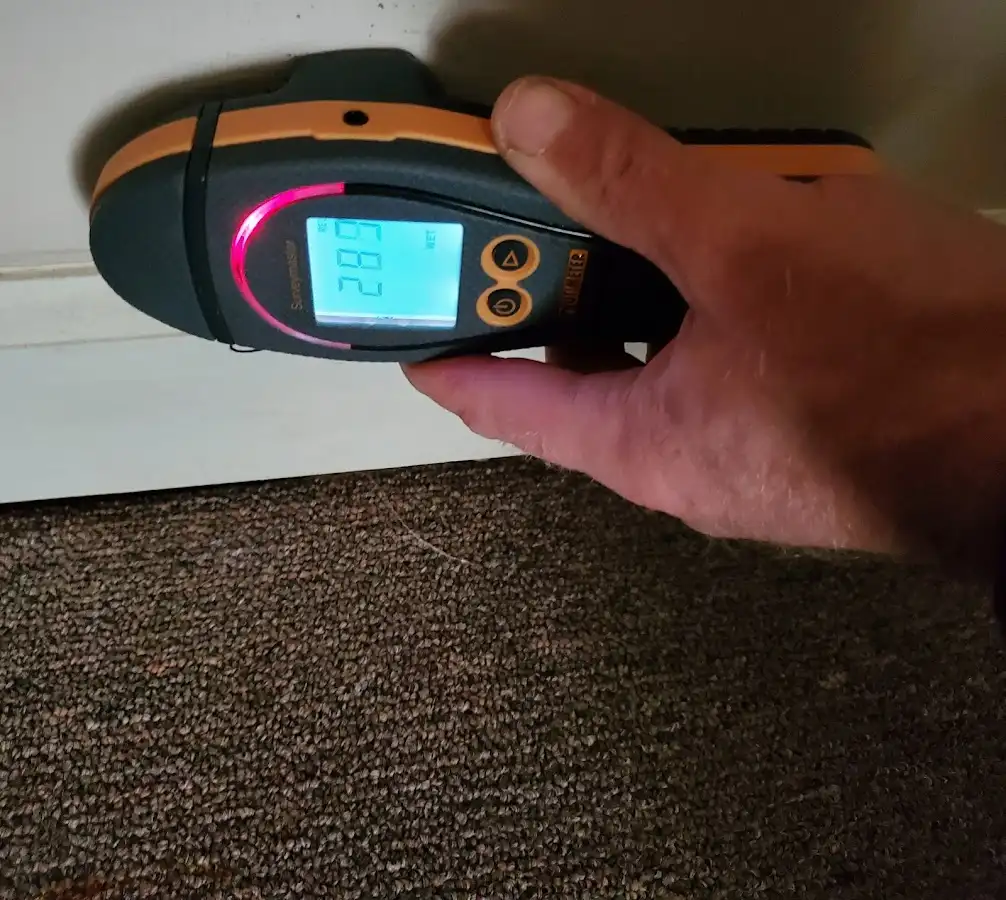 Moisture detection at baseboard during Storm Damage Restoration in Sebastian